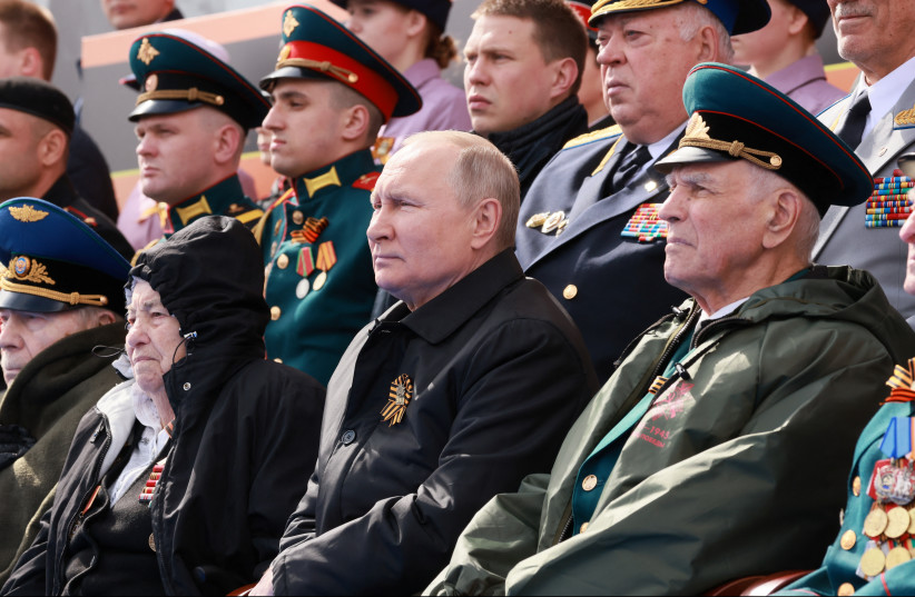  Russian President Vladimir Putin watches a military parade on Victory Day, which marks the 77th anniversary of the victory over Nazi Germany in World War Two, in Red Square in central Moscow, Russia May 9, 2022. (photo credit: SPUTNIK/MIKHAIL METZEL/POOL VIA REUTERS)