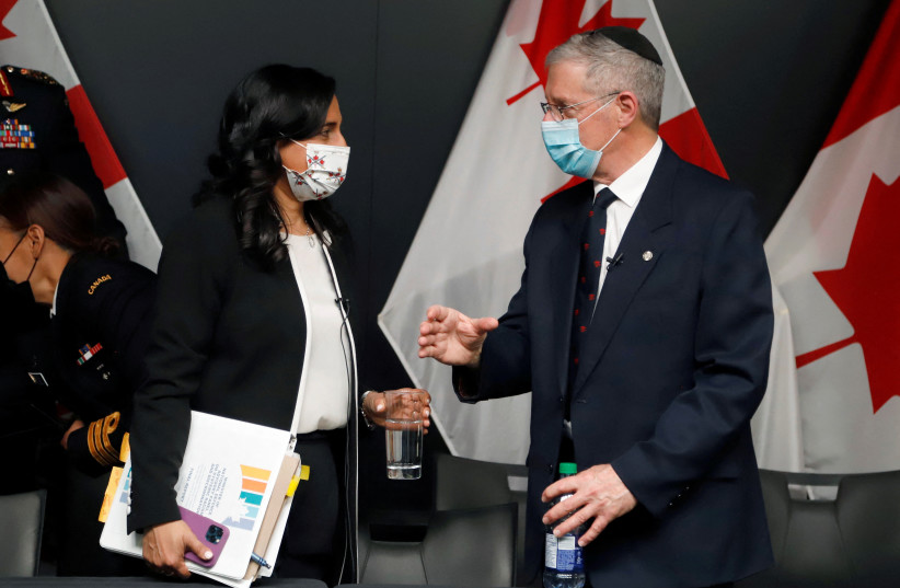  Canada's Defence Minister Anita Anand speaks with Retired Major-General Ed Fitch, a member of an advisory panel that delivered a report on systemic racism, in Ottawa, Ontario, Canada, April 25, 2022.  (photo credit: REUTERS/PATRICK DOYLE)