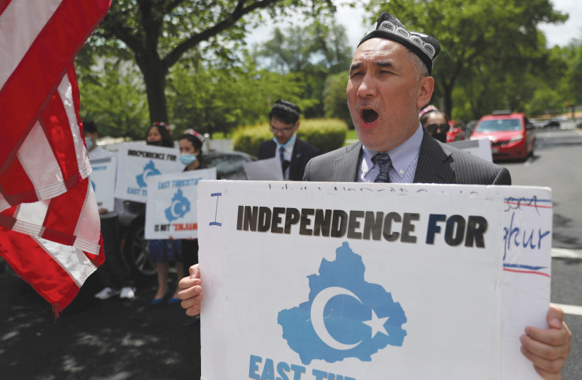  DEMONSTRATORS PROTEST in front of the US State Department, urging the international community to take action against China’s treatment of the Uighur people in East Turkistan. (photo credit: LEAH MILLIS/REUTERS)