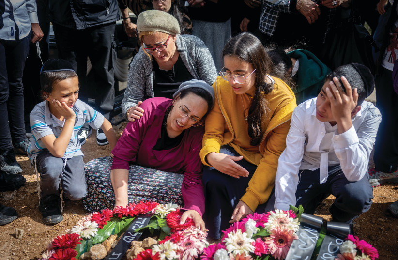  MOURNERS WEEP at the grave of Boaz Gol, murdered in the Elad terrorist attack on Thursday. If the terrorists who chopped Jews to death in Elad are not the very epitome of evil, the word has no meaning. (photo credit: YONATAN SINDEL/FLASH90)