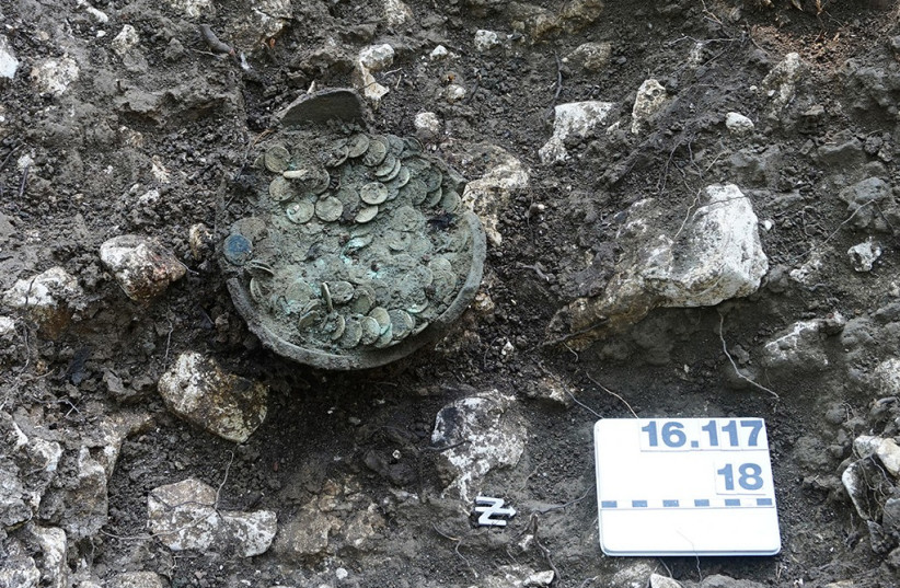  The ceramic pot with the coins after professional excavation by employees of Archeology Baselland. (photo credit: ARCHAEOLOGY BASELLAND)