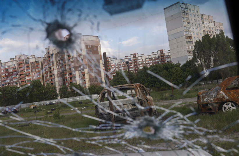  Burnt cars are pictured through the glass of a damaged car in Saltivka neighbourhood, amid Russia's attack on Ukraine, in Kharkiv, Ukraine, May 10, 2022. (photo credit: REUTERS/RICARDO MORAES)