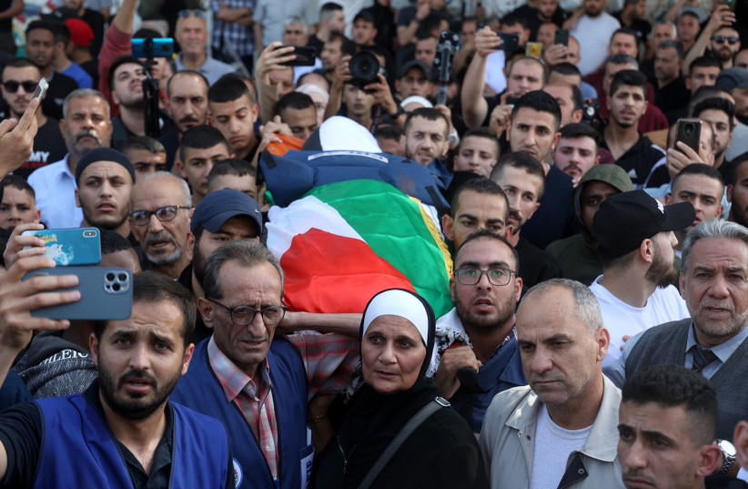  Mourners carry the body of veteran Al Jazeera Palestinian journalist Shireen Abu Aqleh, who was killed during clashes between Palestinian gunmen and IDF troops in Jenin on May 11, 2022. (credit: JAAFAR ASHTIYEH/AFP via Getty Images)