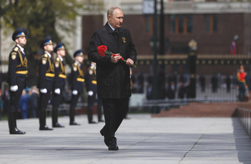  RUSSIAN PRESIDENT Vladimir Putin attends a flower-laying ceremony at the Tomb of the Unknown Soldier in Moscow, on Monday, Victory Day. (photo credit: SPUTNIK/REUTERS)