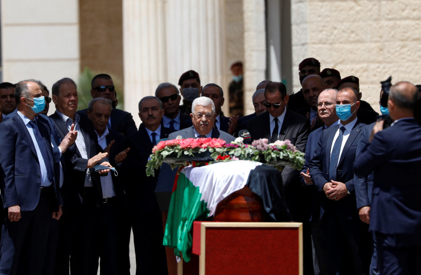  Palestinian President Mahmoud Abbas bids farewell to Al Jazeera journalist Shireen Abu Akleh, who was killed during a live fire exchange between Palestinians and IDF, in Ramallah in the West Bank May 12, 2022. (photo credit: REUTERS/MOHAMAD TOROKMAN)