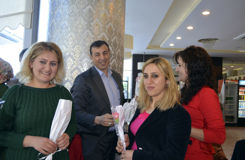  ABDULLAH DEMIRBAS (second L), then-mayor of the Sur municipality, meets employees during an event ahead of International Women’s Day, in Diyarbakir, Turkey, 2013. (photo credit: Mehmet Engin/Reuters)