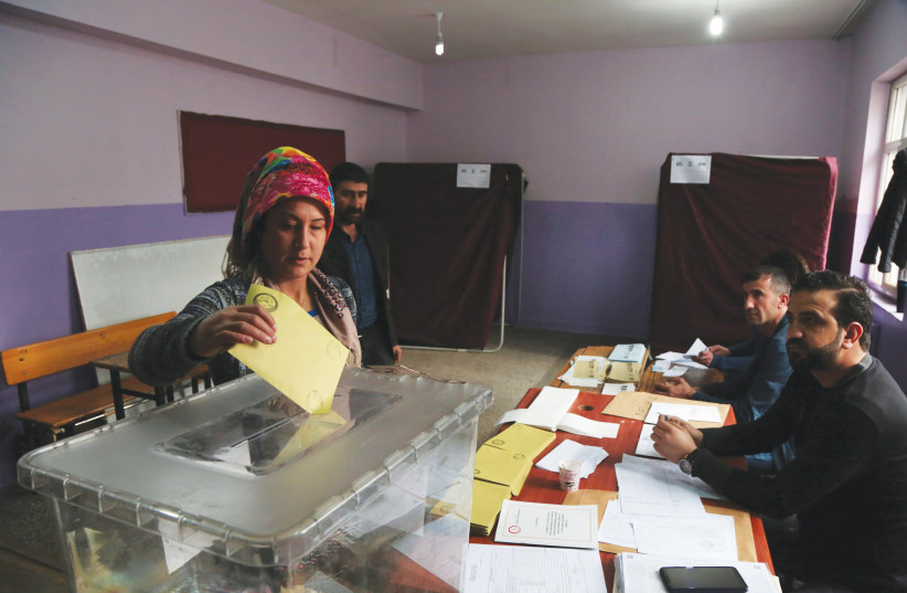  CASTING A ballot during the municipal elections in Diyarbakir. (credit: Sertac Kayar/Reuters)