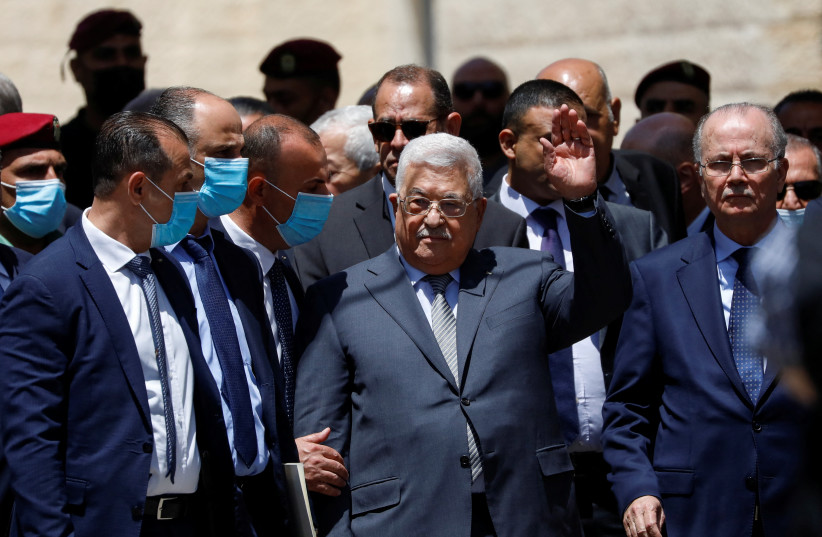  Palestinian President Mahmoud Abbas waves to people as he bids farewell to Al Jazeera journalist Shireen Abu Akleh, who was killed during a live fire exchange in Jenin, in Ramallah in the West Bank May 12, 2022. (credit: REUTERS/MOHAMAD TOROKMAN)