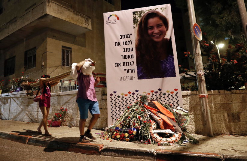  PLACING FLOWERS in memory of Shira Banki, murdered at the 2015 Jerusalem pride parade.  (photo credit: THOMAS COEX/AFP via GETTY IMAGES)