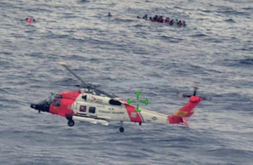  A US Coast Guard helicopter arrives on scene after a migrant vessel capsized north of Desecheo Island, Puerto Rico May 12, 2022. (credit: UNITED STATES COAST GUARD/HANDOUT VIA REUTERS)