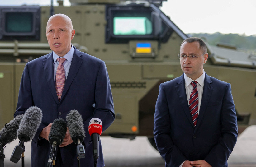  Defense Minister Peter Dutton makes an announcement regarding defensive military assistance to Ukraine as a Bushmaster PMV is loaded into a C-17 Globemaster in Brisbane, Australia, April 8, 2022. (credit: AAP Image/Russell Freeman via REUTERS)