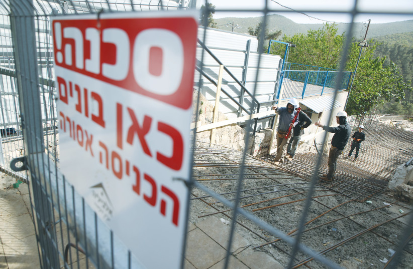  A SIGN warns of construction work at the Meron site for the coming week’s Lag Ba’omer celebrations, in this photo taken last month. Guardians of the site assure us that the new rules and the essential ‘missing’ construction has been completed. (photo credit: David Cohen/Flash90)