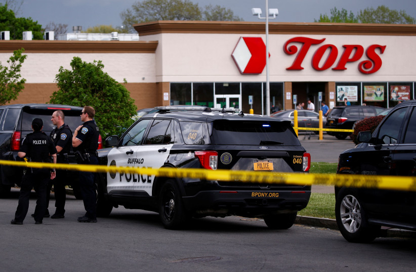 Police officers secure the scene after a shooting at TOPS supermarket in Buffalo, New York, US, May 15, 2022. (photo credit: REUTERS/JEFFREY T. BARNES)