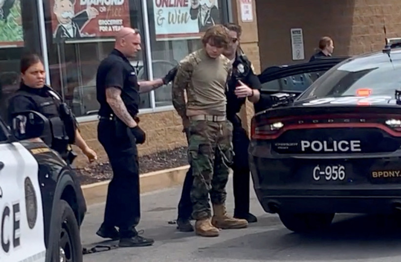  A man is detained following a mass shooting in the parking lot of TOPS supermarket, in a still image from a social media video in Buffalo. (photo credit: Courtesy of BigDawg/ via REUTERS)