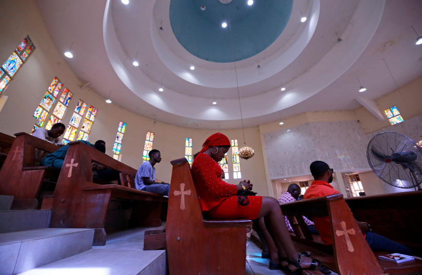  Christian worshippers sit during a mass at the St Gabriel Catholic church, as government struggles to control the spread of the coronavirus disease (COVID-19) in Abuja, Nigeria March 22, 2020. (photo credit: REUTERS/AFOLABI SOTUNDE)