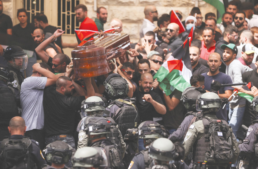  CLASHES ERUPT between rioters and security forces during the funeral of Shireen Abu Akleh in Jerusalem on Friday.  (photo credit: AMMAR AWAD/REUTERS)