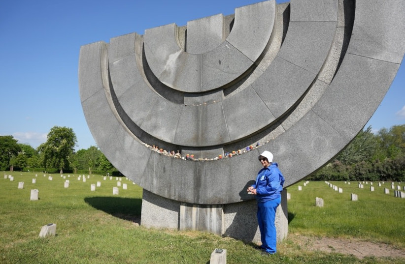 Second generation to Holocaust survivor light a remembrance candle at the camp  (credit:  Dale Bluestein)