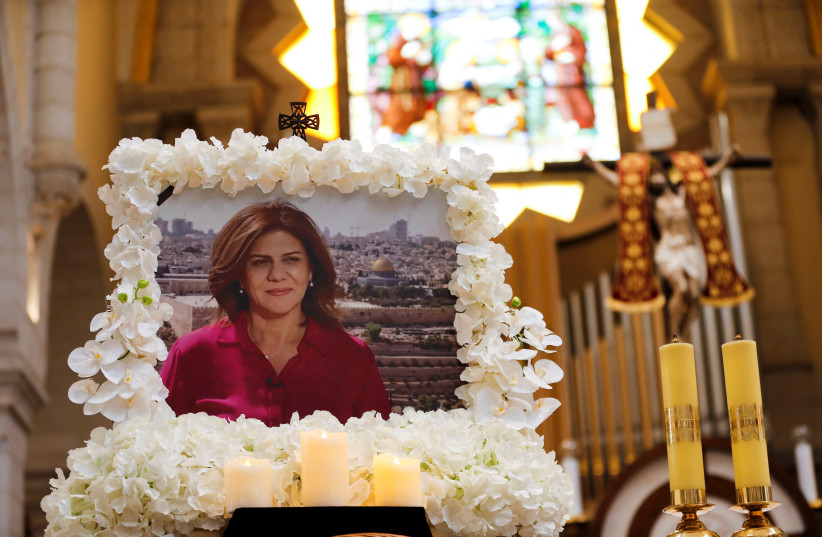 A portrait of Al Jazeera journalist Shireen Abu Akleh, who was killed during an Israeli raid, is displayed during a special mass in her memory in the Church of the Nativity in Bethlehem, in the West Bank, May 16, 2022. (photo credit: MUSSA QAWASMA/REUTERS)