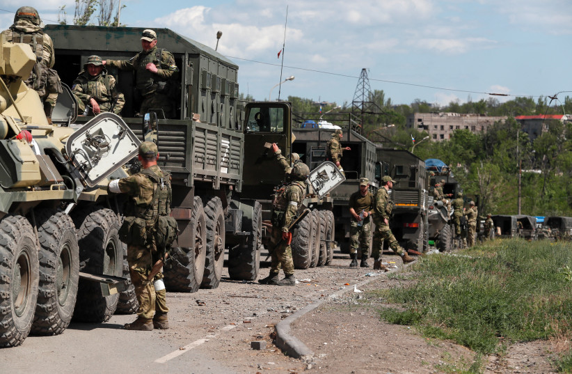 A convoy of pro-Russian troops is seen before the expected evacuation of wounded Ukrainian soldiers from the besieged Azovstal steel mill in the course of Ukraine-Russia conflict in Mariupol, Ukraine, May 16, 2022. (photo credit: REUTERS/ALEXANDER ERMOCHENKO)