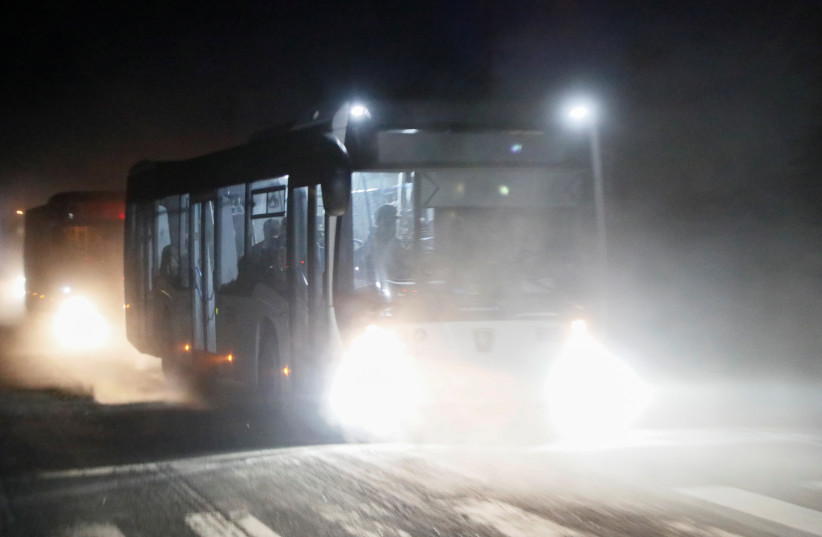 Buses carrying service members of Ukrainian forces from the besieged Azovstal steel mill drive away under escort of the pro-Russian military in the course of Ukraine-Russia conflict in Mariupol, Ukraine, May 16, 2022. (credit: REUTERS/ALEXANDER ERMOCHENKO)
