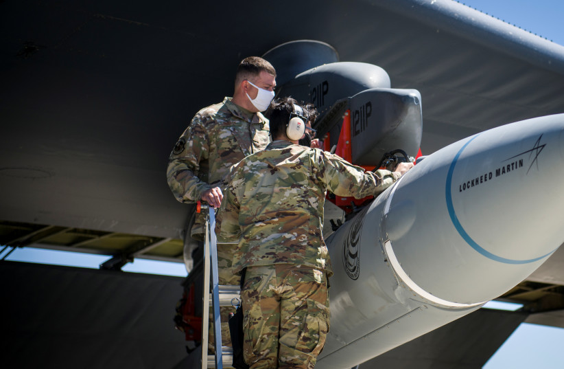 Master Sgt. John Malloy and Staff Sgt. Jacob Puente, both from 912th Aircraft Maintenance Squadron, secure the AGM-183A Air-launched Rapid Response Weapon Instrumented Measurement Vehicle 2 (ARRW IMV-2) as it is loaded under the wing of a B-52H Stratofortress at Edwards Air Force Base, California. (photo credit: US AIR FORCE/GIANCARLO CASEM/HANDOUT VIA REUTERS)