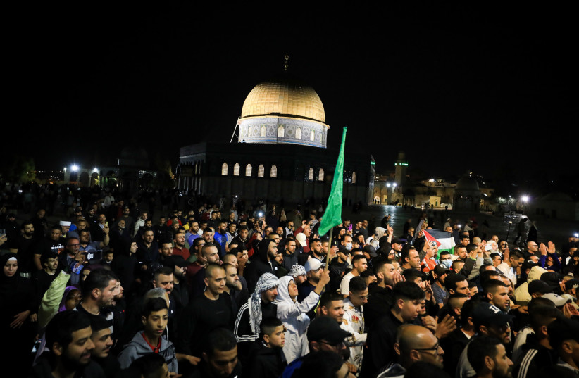  Palestinians carry the coffin of Walid al-Sharif, during his funeral at the Al-Aqsa mosque compound in Jerusalem Old City on May 16, 2022. (photo credit: JAMAL AWAD/FLASH90)