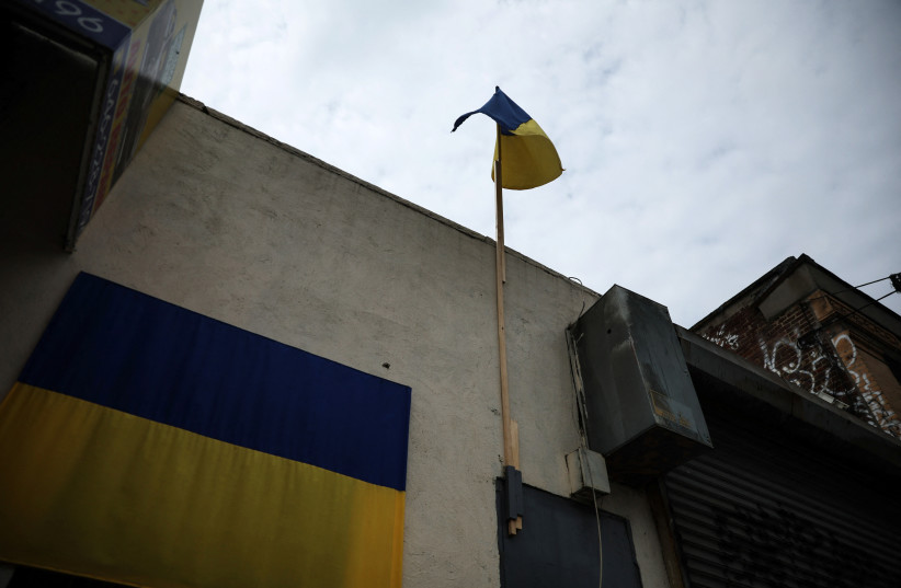  The flag of Ukraine hangs and flies, as the Russian invasion of Ukraine continues, outside a shop near the service road of the Major Deegan Expressway in the Bronx borough of New York City, US, May 16, 2022.  (credit: REUTERS/SHANNON STAPLETON)