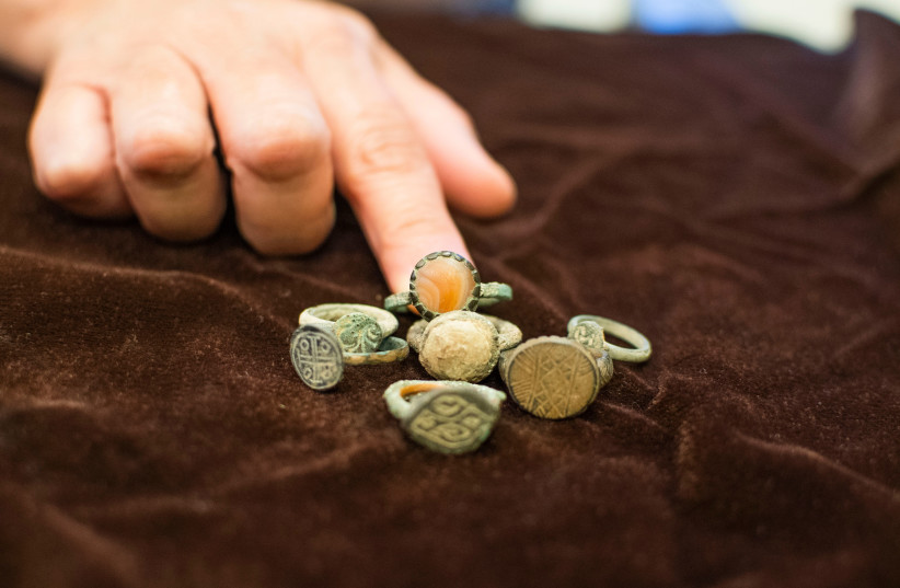  Rare ancient coins found in the home of an illegal antiquities dealer in Modi'in.  (credit: YOLI SCHWARTZ/IAA)