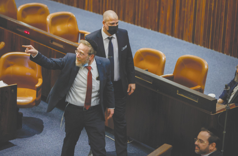 MK YITZHAK PINDRUS points an accusing finger, as he is escorted out of the Knesset plenum during a stormy debate, in February. (photo credit: OLIVIER FITOUSSI/FLASH90)