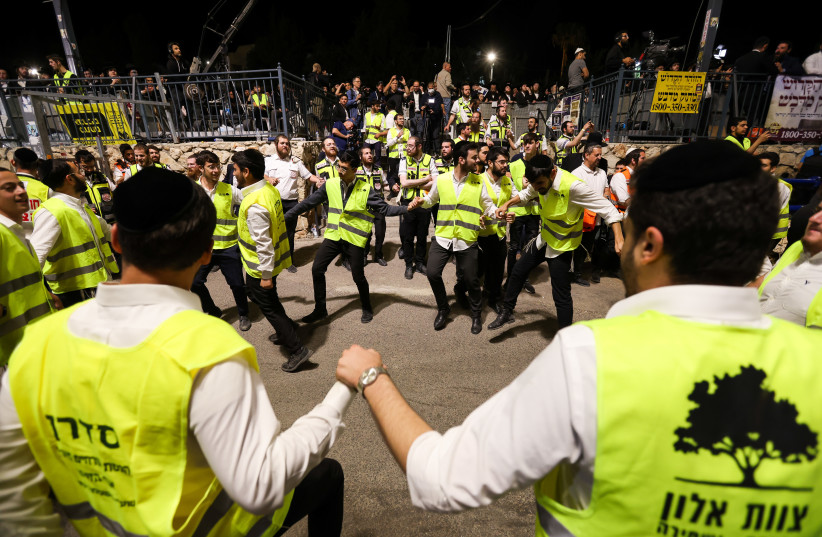  Jews dance during Lag Ba'omer celebrations, in Meron on May 18, 2022. (credit: David Cohen/Flash90)