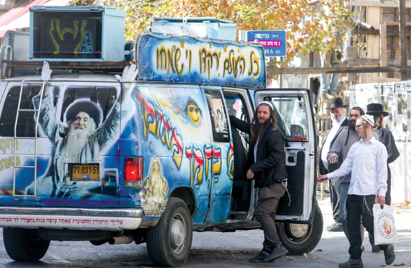  Reb Nachman’s followers drive through Jerusalem’s Geula neighborhood in a van decorated with his image and name. (photo credit: MARC ISRAEL SELLEM)