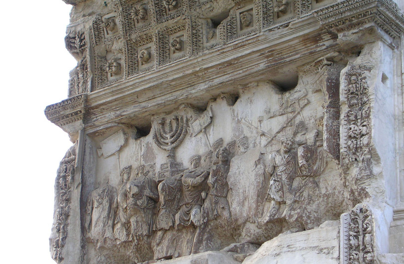  TEMPLE BOOTY: The menorah as seen as part of the Roman Triumphal panel on the Arch of Titus. (photo credit: Wikimedia Commons)