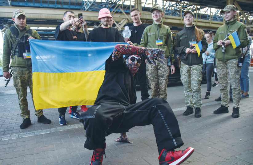  THE LEAD singer of Eurovision Song Contest winners Kalush Orchestra performs for members of Ukraine’s State Border Guard Service as the band arrives at the Ukraine-Poland border on its return to the country.  (photo credit: Pavlo Palamarchuk/Reuters)
