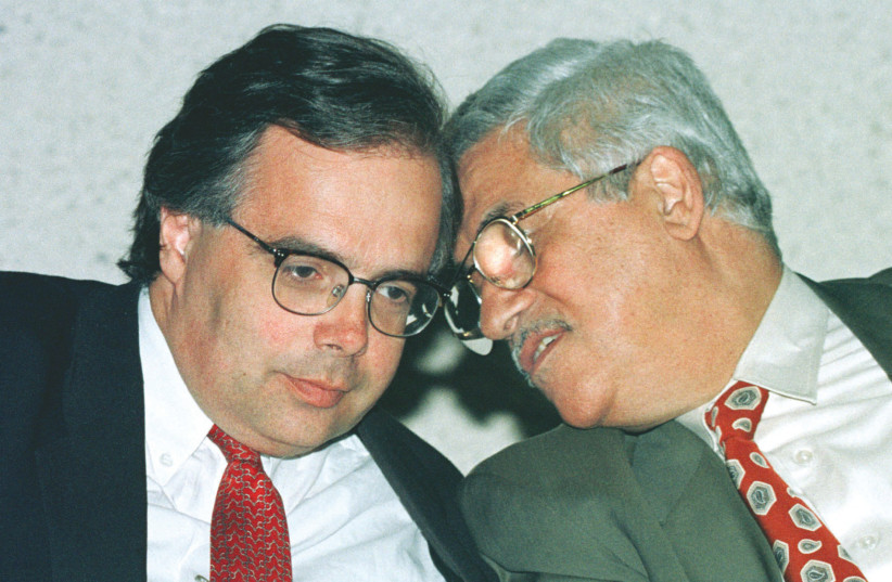  THEN-SENIOR Israeli and Palestinian negotiators Uri Savir (left) and Mahmoud Abbas confer during a news conference at the close of a day of final status negotiations, in May 1996.  (photo credit: JIM HOLLANDER/REUTERS)