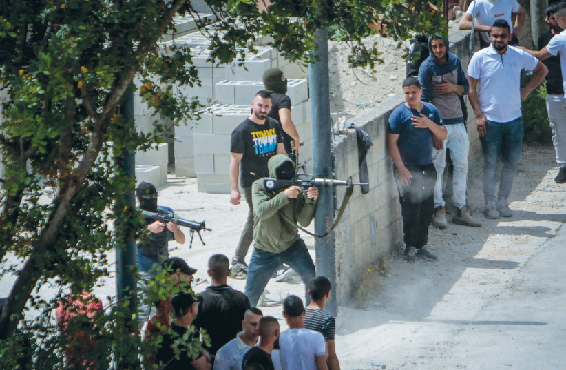  PALESTINIAN GUNMEN fire toward Israeli forces during an Israeli raid in the West Bank city of Jenin, last Friday. So yes, Israeli troops and police have aggressively escalated their counter-terrorist operations.  (photo credit: NASSER ISHTAYEH/FLASH90)
