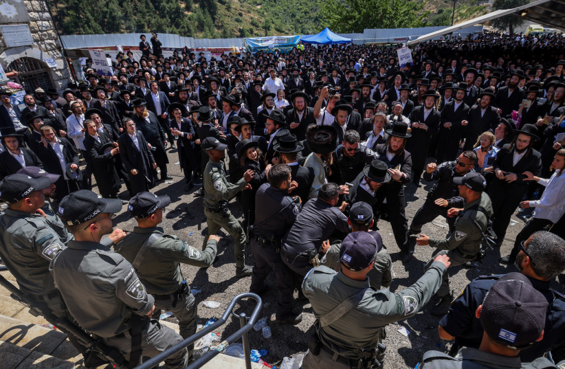  Ultra-Orthodox Jews clash with police during Lag Ba'omer celebrations, in Meron, on May 19, 2022. (photo credit: David Cohen/Flash90)