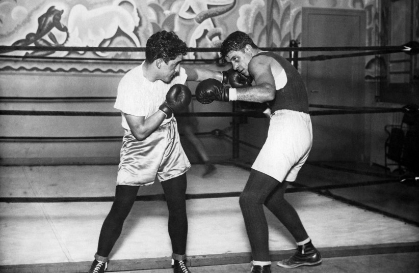  Tunisian Jewish boxer Victor Perez, left, is featured on the new podcast "Holocaust Histories." (photo credit: Jeff Dickson/AFP via Getty Images)