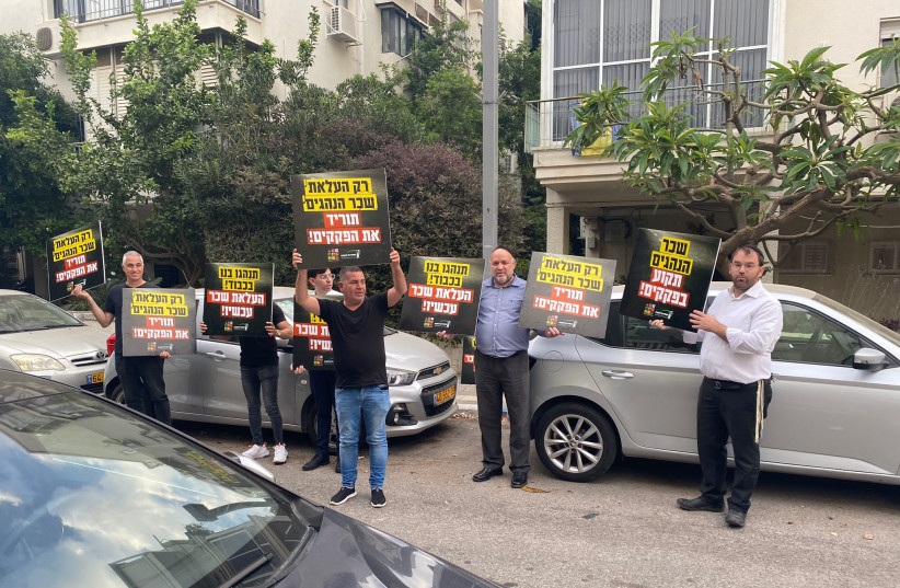  Bus drivers are seen protesting outside the home of Transportation Minister Merav Michaeli, on May 22, 2022. (credit: BUS DRIVER'S UNION)