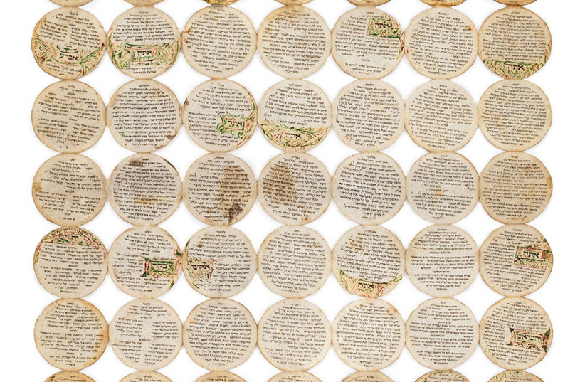  The collection of pieces of the smallest known Hebrew manuscript which all together make up the Passover Haggadah. (credit: KEDEM AUCTION HOUSE)