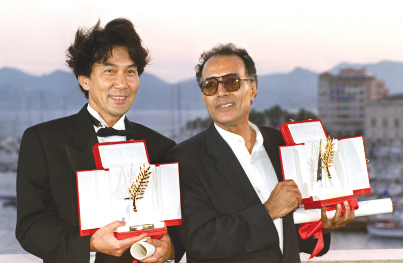  IRANIAN DIRECTOR Abbas Kiarostami (left) holds his Palme d'Or alongside Japanese actor Koji Yakusho at the Cannes Film Festival of 1997. (photo credit: JACQUES MUNCH/REUTERS)