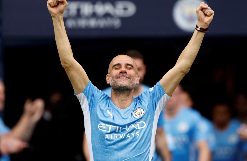 Manchester City manager Pep Guardiola celebrates after winning the Premier League, Etihad Stadium, Manchester, Britain, May 22, 2022. (credit: Action Images via Reuters/Jason Cairnduff)
