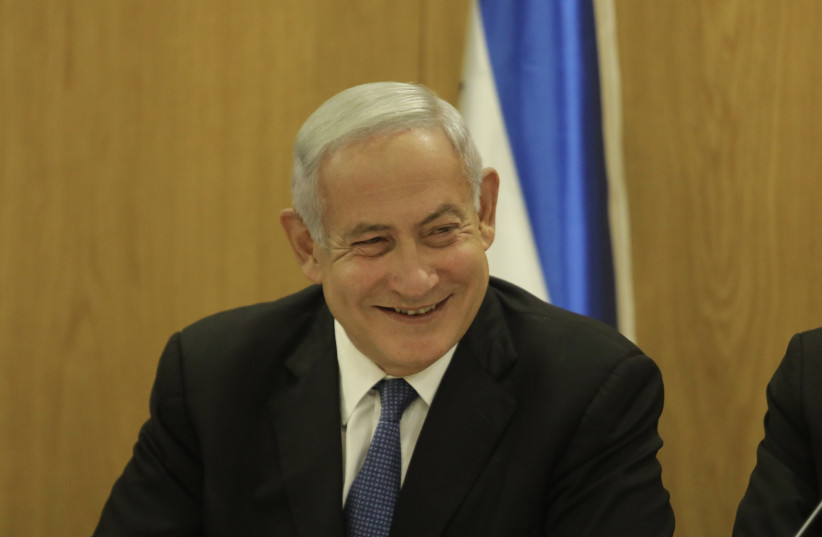  Former Israeli prime minister Benjamin Netanyahu is seen smiling at the Knesset in Jerusalem, on May 23, 2022. (photo credit: MARC ISRAEL SELLEM/THE JERUSALEM POST)
