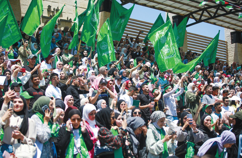  PALESTINIAN STUDENTS wave Hamas flags during a rally at Birzeit University, near Ramallah, last week. (photo credit: FLASH90)