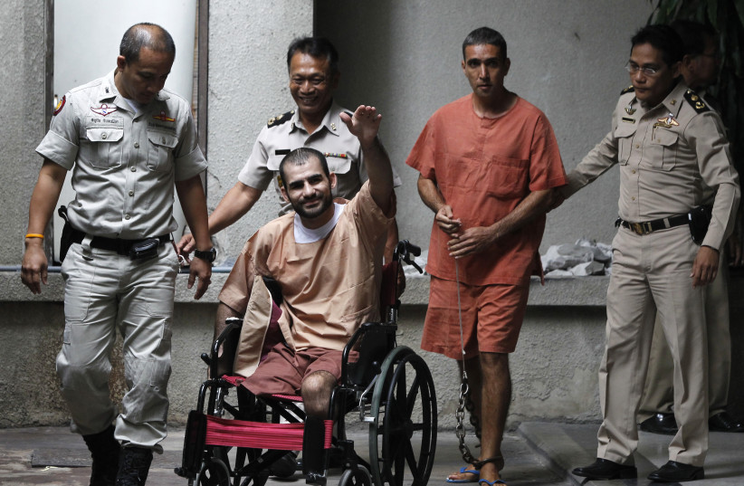  Thai prison officers escort Iranian Saeid Moradi, 29, (in wheelchair) and Mohammad Khazaei, 43, as they leave the Bangkok South Criminal Court August 22, 2013 (credit: REUTERS)