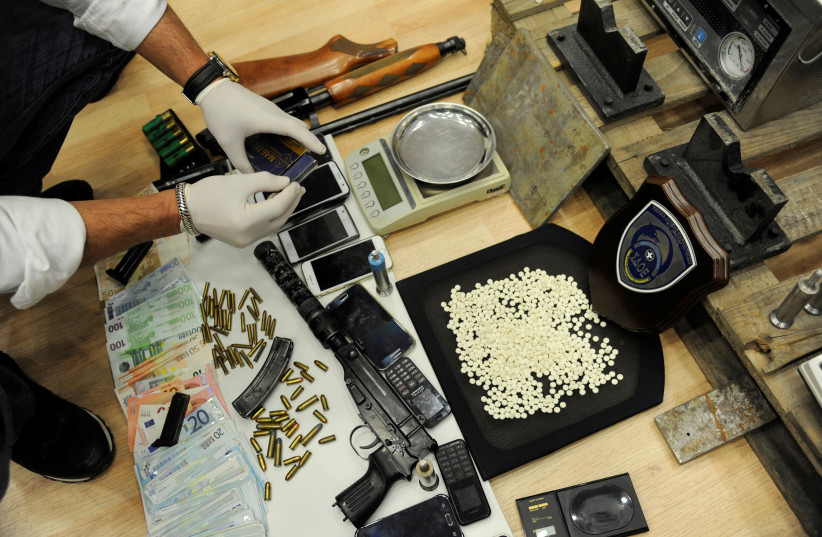 Greek authorities present confiscated guns, money and Captagon amphetamine pills after dismantling a criminal ring near Elefsina, southwest of Athens, Greece, March 6, 2017. (credit: REUTERS/MICHALIS KARAGIANNIS)