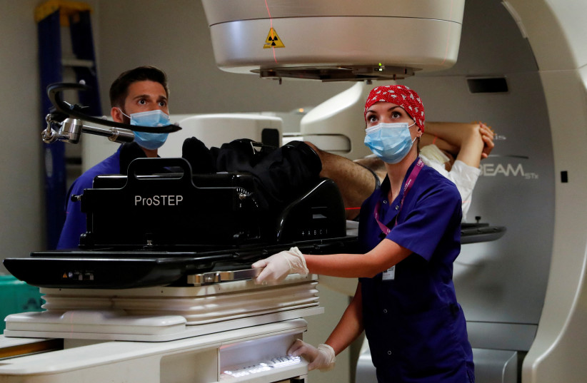  Medical staff performs a stereotactic radiotherapy treatment at the UPMC Hillman Cancer Center San Pietro FBF, during the coronavirus disease (COVID-19) outbreak, in Rome, Italy May 27, 2020.  (photo credit: REUTERS/YARA NARDI)
