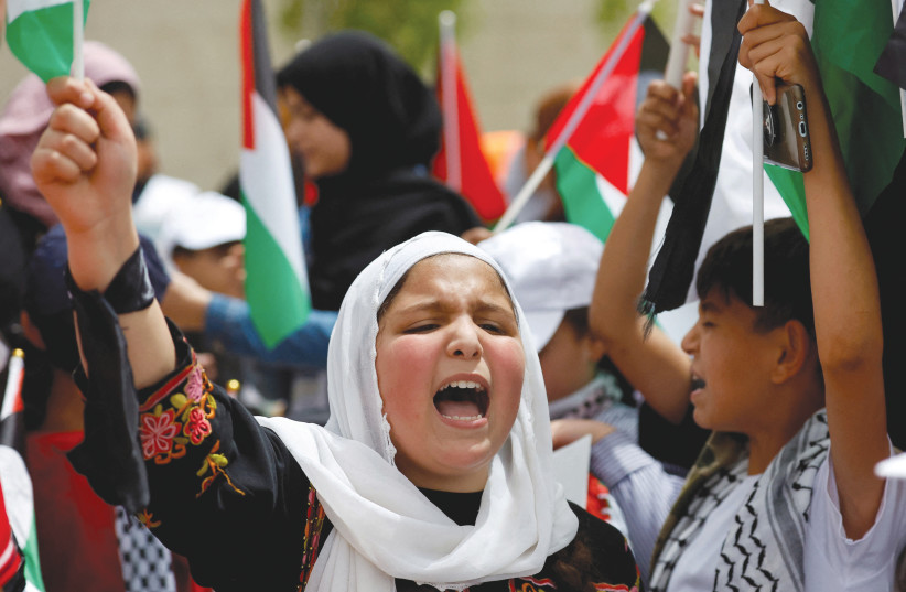  A PALESTINIAN girl takes part in a rally marking the 74th anniversary of the Nakba, in Ramallah, May 15. (photo credit: REUTERS)
