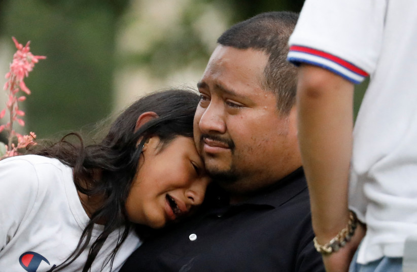  People react outside the Sgt Willie de Leon Civic Center, where students had been transported from Robb Elementary School after a shooting in Uvalde, Texas, US May 24, 2022. (photo credit: REUTERS/MARCO BELLO)