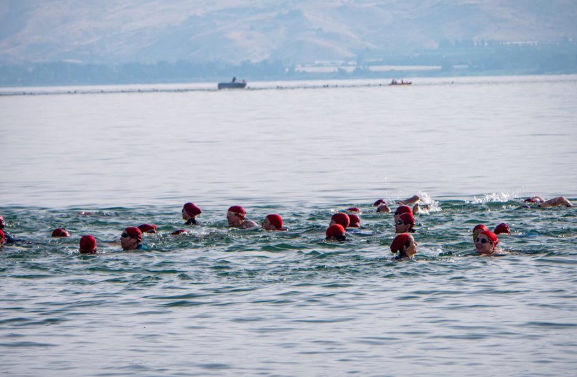  Women begin their swim across the Kinneret in the annual 'Swim4Sadna' event that raises funds for a center for people with disabilities.   (credit: LAURA BEN DAVID)