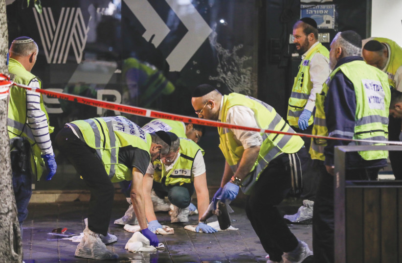  POLICE AND rescue personnel work at the scene of last month’s terror attack in Tel Aviv in which three people were killed. The terror wave has been dominated by assailants who decided on their own to launch indiscriminate attacks. (photo credit: NOAM REVKIN FENTON/FLASH90)